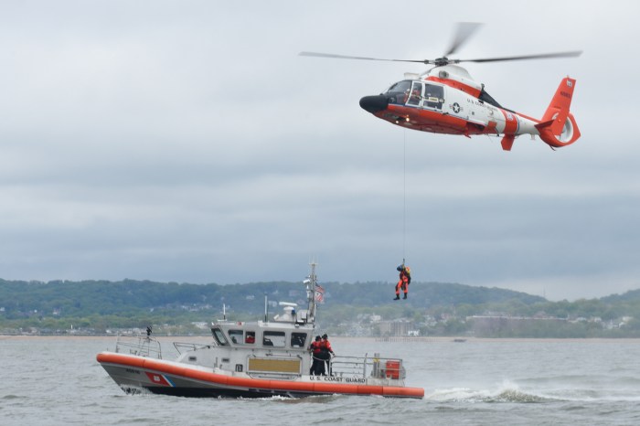 A rescue helicopter is hovering over a person